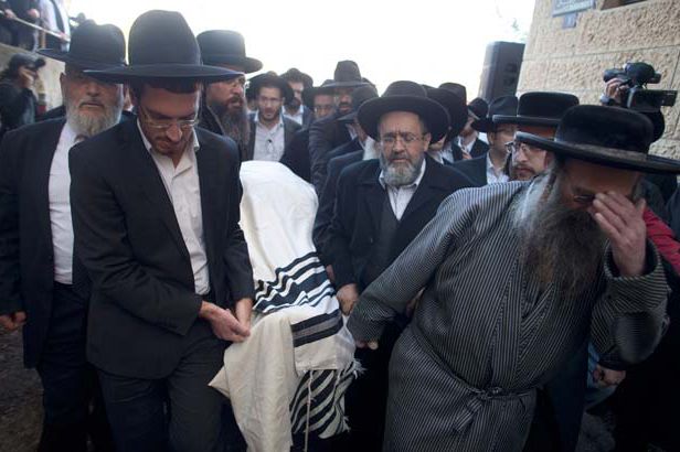 Ultra Orthodox Jewish men carry the coverd body of Rabbi Moshe Twersky during his funeral
